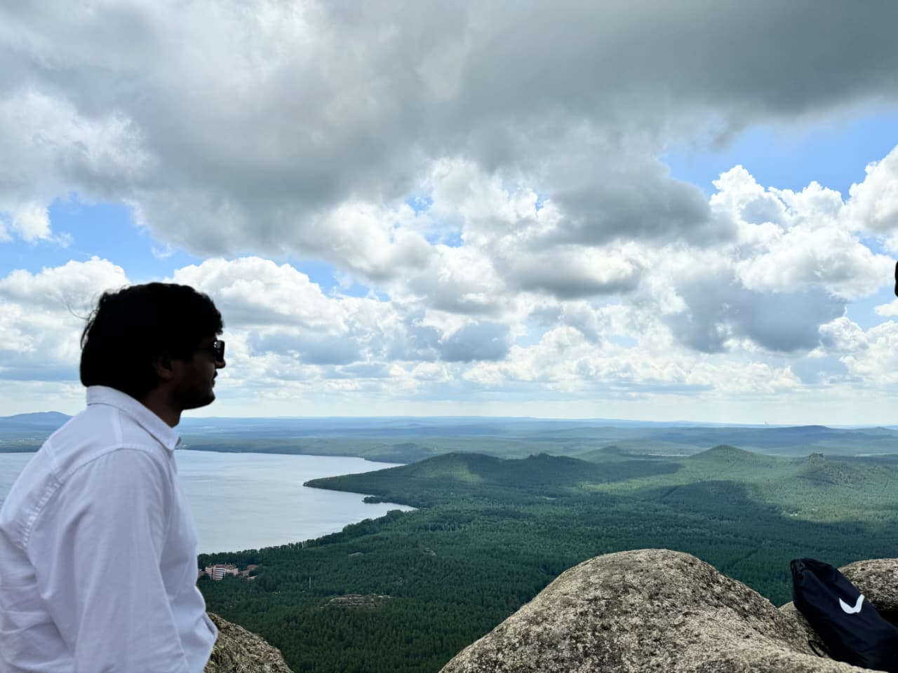 Kashif Khan at a mountain viewpoint overlooking a lake