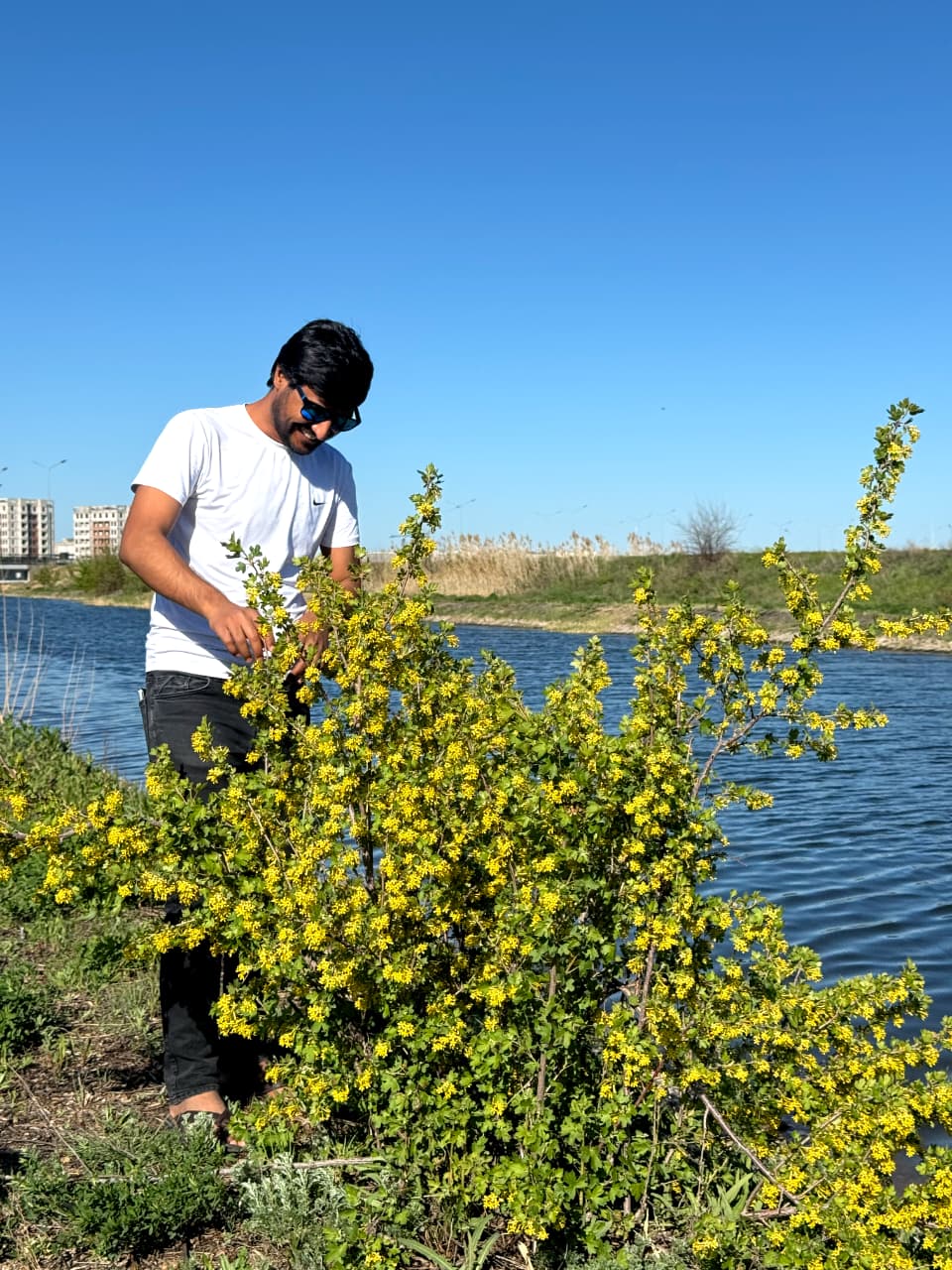 Kashif Khan beside a lake during spring